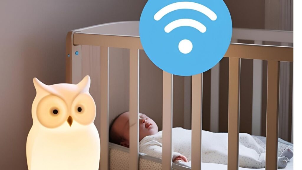 Baby sleeping peacefully with Owlet base station glowing in a soft-lit nursery.