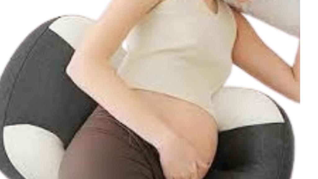 Pregnant woman using a pregnancy pillow to support belly and reduce lower back pain while side sleeping