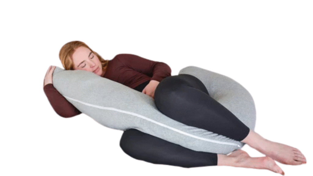 Pregnant woman lying on her side using a gray C shape pregnancy pillow for belly and back support
